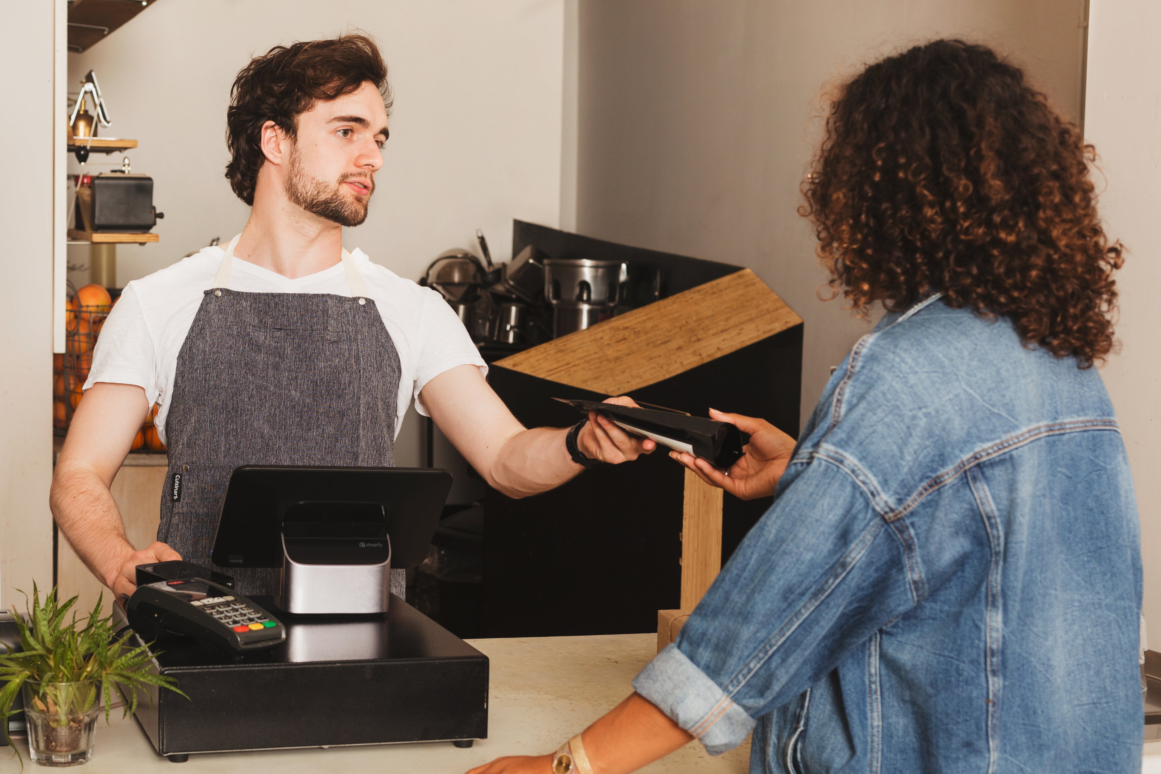 retail worker handing over product