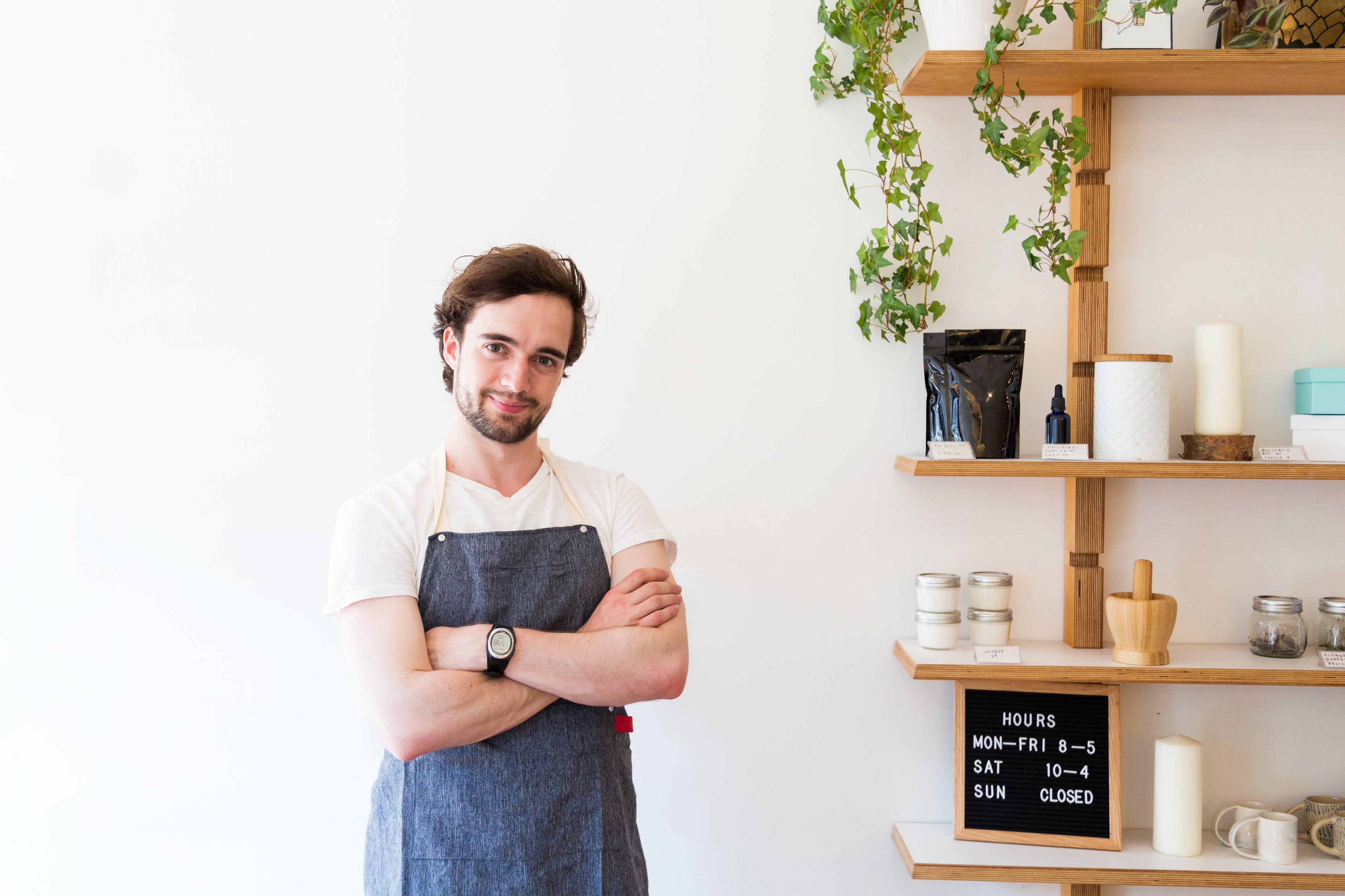 Person standing with arms crossed in retail store